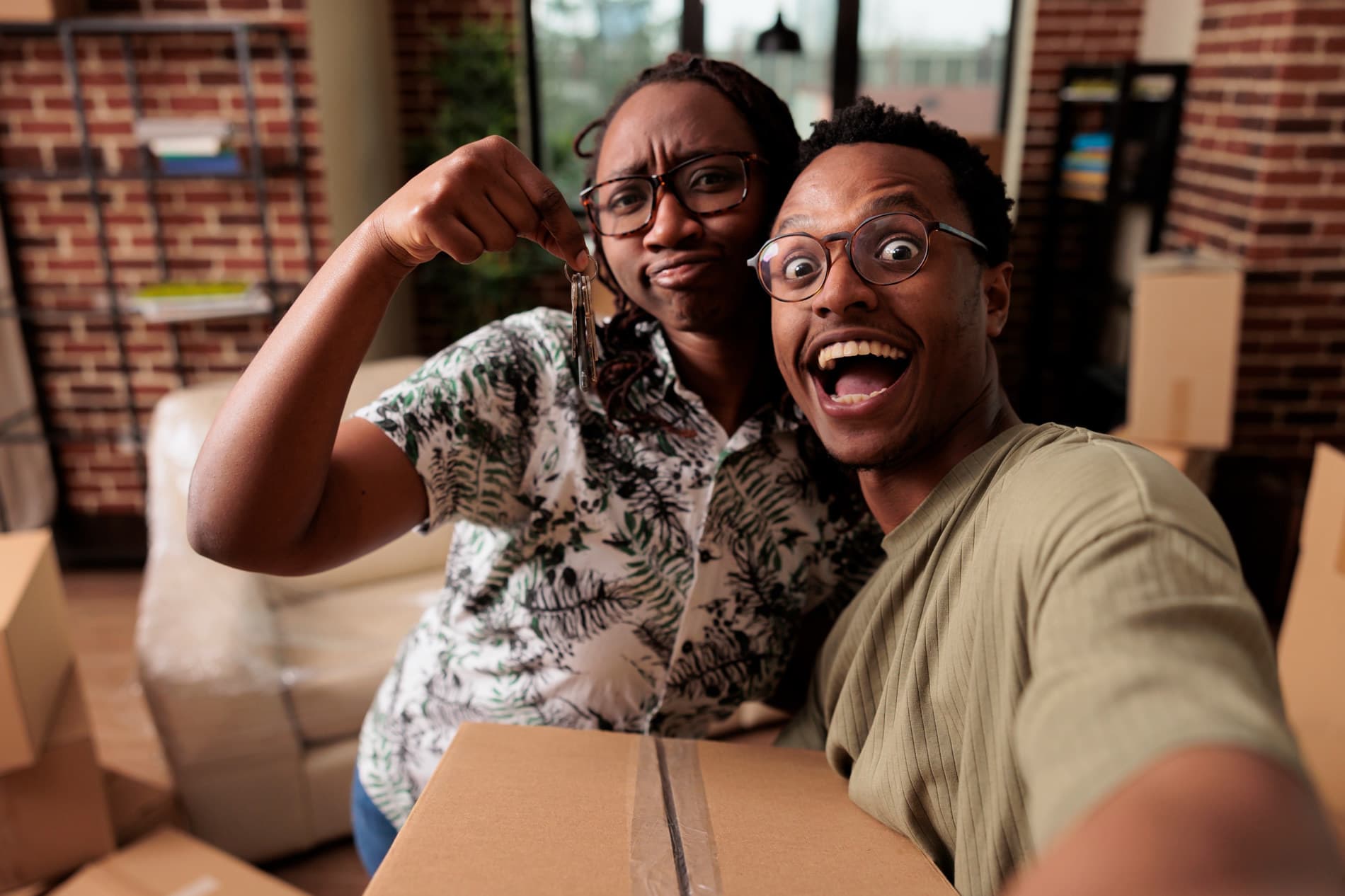 African couple celebrating new home keys